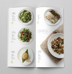 an open magazine with plates of food on the cover and in it's pages