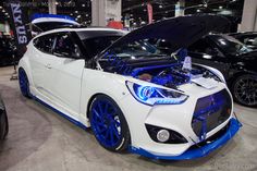 a white car with its hood open on display