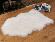 PRICES MAY VARY. LUXURY SHEEPSKIN RUG - With exquisite softness and a luxuriously dense pile -in a natural shape that looks perfect as an area rug, or draped on your favorite armchair. PREMIUM QUALITY - Our White Faux Fur Rug is thicker, fluffier and softer then others. Includes a suede backing with reinforced stitching. PERFECT SIZE - At 2x3 feet this white rug will easily fit anywhere. ANIMAL CRUELTY FREE - Here at O'ranch we firmly opposed to animal cruelty. Our white fluffy rug is made from White Area Rug Bedroom, Panda Kindergarten, White Fluffy Rug, White Faux Fur Rug, Dorm Gifts, Fuzzy Rug, Faux Fur Area Rug, Ranch House Decor, Diy Tumblr