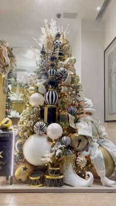 a christmas tree is decorated with gold and white ornaments