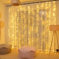 a room with lights on the curtains and a bean bag chair in front of it