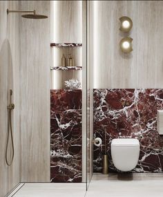 a bathroom with marble walls and flooring next to a white toilet in the corner