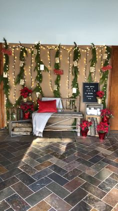 a room decorated for christmas with garland and lights