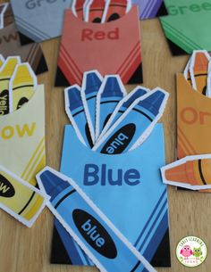 colorful paper bags with the word blue on them and an owl sitting in front of them