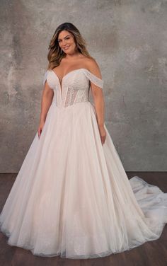 a woman in a wedding dress posing for the camera with her hands on her hips