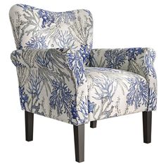 an upholstered chair with blue and white flowers on the back is shown in front of a white background