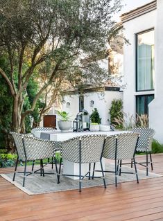 an outdoor table and chairs on a wooden deck