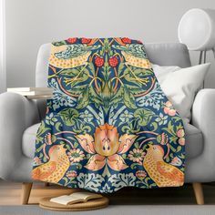 an artisticly designed throw blanket on a couch