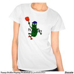 a women's t - shirt with an image of a green frog holding a red balloon