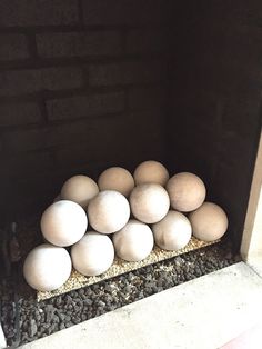 several eggs are stacked on top of each other in the corner of a brick wall