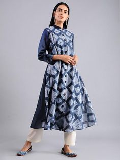 An Indigo diamond shaped all over shibori jacket dress with mirror work and flower shapped handmade buttons. This dress comes with a separate matching slip in mul. Features: Front open jacket dress with 3/4th sleeves Shell - pure cotton silk fabric Lining - separate matching slip in soft cotton Handmade in India Measurements: Size XS : Bust-34", Waist-33", Hip-Flared, Shoulder-14", Length-47", Sleeve length-18" Size S : Bust-36", Waist-35", Hip-Flared, Shoulder-14.5", Length-47", Sleeve length-1 Cotton Silk Straight Kurta With Set-in Sleeves, Cotton Silk Kurta With Set-in Sleeves, Traditional Festive Dresses With Set-in Sleeves, Long Sleeve Indigo Chanderi Kurta, Long Sleeve Chanderi Kurta In Indigo, Indigo Cotton Silk Straight Kurta, Fitted Cotton Silk Long Sleeve Dress, Transitional Dresses With Printed Motifs, Fitted Long Sleeve Dress In Cotton Silk