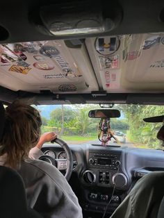 two people sitting in the driver's seat of a vehicle