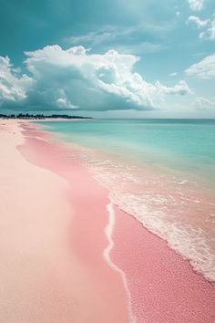 the beach is pink and blue with white clouds