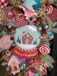 a christmas wreath with gingerbreads, candy canes and other holiday decorations on it