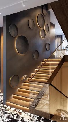 an elegant staircase with metal circles on the wall