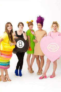 four women dressed up in costumes posing for the camera with their hands on their hipss