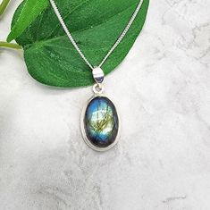 Beautiful flash in this oval cut labradorite stone (characteristic of these striking stones) which rests in a simple sterling silver bezel setting.  The labradorite pendant is perfect for everyday wear as it goes with everything and offers a gorgeous show of color when the light strikes the stone. The oval labradorite cabochon is 15x10 mm in size.  Both the setting and curb chain are sterling silver. Items are shown larger in pictures to show detail - please note the dimensions. Jewelry is packaged in a cotton lined gift box. See more Bonny Jewelry at http://bonnyjewelry.etsy.com Oval Labradorite Necklace With Large Stone, Oval Labradorite Necklace For Gift, Oval Labradorite Cabochon Necklace, Silver Oval Labradorite Necklace, Oval Labradorite Silver Necklace, Silver Labradorite Oval Necklace, Cabochon Necklace, Silver Items, Labradorite Necklace