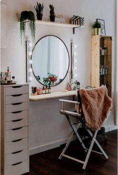 a dressing table with a mirror and some plants