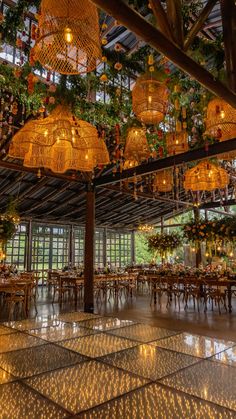 the inside of a building with tables and chandeliers hanging from it's ceiling