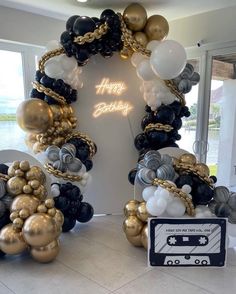 a birthday decoration with balloons and streamers