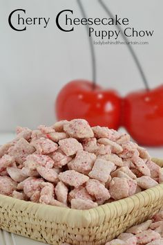 cherry cheesecake puppy chow is in a wicker basket next to two cherries