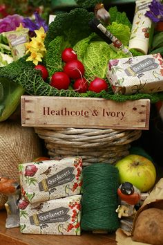 a basket filled with lots of vegetables next to fruit and veggies on top of a table