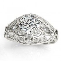 an antique style diamond ring with filigrees on the shoulders and sides, set in white gold