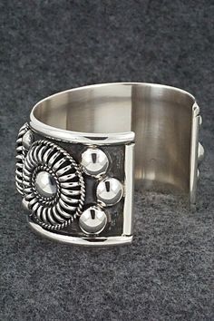 This stunning sterling silver bracelet was made by Navajo silversmith Thomas Charley. The inside is signed TC and stamped sterling.Size: 5 3/8" (will fit up to a 6 3/4" wrist)Gap: 1 1/4"Width: 1 1/2"Free shipping on all orders! We ship with USPS and always include tracking. All orders ship within a day of payment.Returns are accepted up to 30 days after you receive your order. Just send us a message. Our shop offers cash back or store credit. The item must be returned in new condition. Southwestern Oxidized Bracelet, Artisan Sterling Silver Concho Cuff Bracelet, Artisan Silver Concho Cuff Bracelet, Sterling Silver Round Cuff Bracelet With Oxidized Finish, Adjustable Sterling Silver Concho Bracelets, Nickel-free Southwestern Sterling Silver Bracelet, Unique Sterling Silver Concho Jewelry, Southwestern Sterling Silver Cuff Bracelet In Silver, Southwestern Silver Bracelet With Oxidized Finish