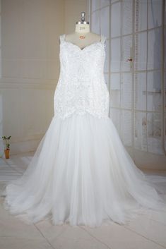 a white wedding dress on display in a room