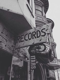 a black and white photo of a building with a sign that reads records on it