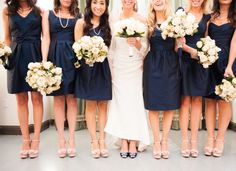 a group of women standing next to each other holding bouquets