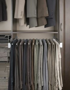 an organized closet with folded shirts and pants