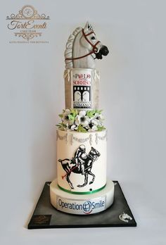 a three tiered cake with a horse on top