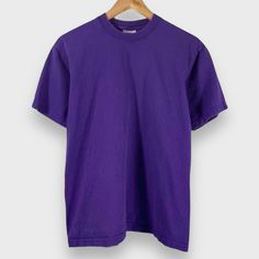 Vintage 1990's blank purple tee. Pro Club tag size medium, made in USA. Fade, normal wear. Contact us with any questions.   20.25" pit to pit 26.75" top to bottom   Instagram: @IdleHandsVintage Purple Relaxed Fit T-shirt For Streetwear, Purple Cotton T-shirt For Streetwear, Purple Short Sleeve T-shirt For Streetwear, Basic Purple T-shirt With Relaxed Fit, Basic Purple Short Sleeve T-shirt, Purple Short Sleeve 90s Tops, 90s Style Purple Short Sleeve Tops, Basic Purple Crew Neck T-shirt, Vintage Purple Cotton T-shirt