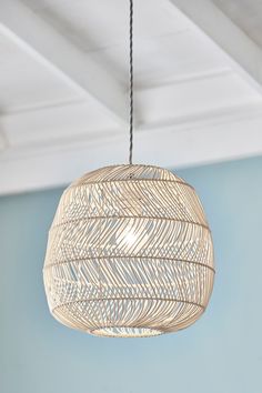 a light fixture hanging from the ceiling in a room with blue walls and white ceilings