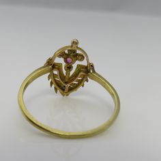 Estate wonderful vintage 18k yellow gold great condition i think is a old stick pin conversion. ruby seed pearl ring size 8. just fabulous. 1.6 grams. 16mm wide in front. estate 1910's beautiful uniique piece. unmarked acid tests for 18k. Yellow Gold Estate Jewelry, Gold Ruby Ring With 17 Jewels For Wedding, Estate Style Oval Gold Jewelry, Estate Style Yellow Gold Ring, Estate Gold Ring As Gift, Estate Yellow Gold Rings For Collectors, Gold Ruby Ring With 17 Jewels For Anniversary, Gold Estate Jewelry Stamped 14k, Estate Jewelry Gold Stamped 14k