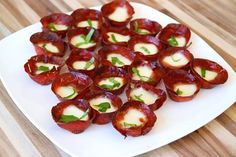 small appetizers are arranged on a white plate