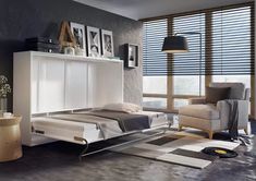 a bedroom with gray walls and white furniture