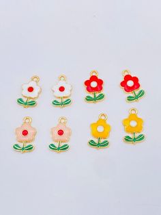 Cute flower charms available in red, yellow, white or pink. Great for charm bracelets.Size White Dangling Pendant Charms, Cute Red Flower Jewelry, Whimsical White Jewelry With Flower Charm, Multicolor Flower Shaped Jewelry With Charms, Multicolor Flower-shaped Jewelry With Charms, Whimsical White Craft Supplies For Gifts, Cute White Charms For Gifts, White Flower Charms Jewelry, White Enamel Charms For Jewelry Making