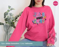 a woman wearing a pink sweatshirt with the words talk to the hand on it