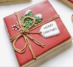 christmas cookies are wrapped in red paper and tied with twine