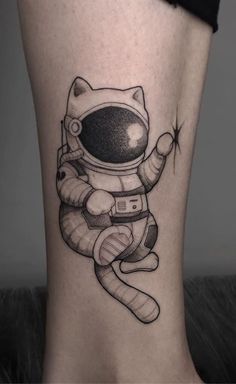 an astronaut cat tattoo on the leg