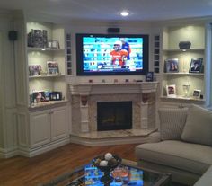 a living room filled with furniture and a flat screen tv mounted above a fire place