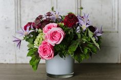 a vase filled with pink and purple flowers