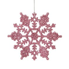 a pink snowflake ornament hanging from a chain on a white background