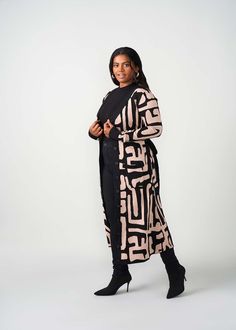 Style#: 7003/P7003BTG We love versatility and the Aisha African Print Cardigan in Black Tan Geometric delivers just that. Wear this gorgeous duster-length cardigan sweater open as a layering accent to your outfit or fully buttoned as a statement dress. Features Contrast color rib knit border and sleeve cuff Regular Length Range: 51-53" Plus Length Range:53 1/2"-54 1/2" 45% cotton, 55% acrylic Designed in the USA, imported Care Instructions Hand wash cold. Do not soak. Do not bleach. Lay flat to Chic Long Sweater Coat For Layering, Chic Black Open Front Sweater Coat, Knit Border, Statement Dress, Cardigan Black, Sleeve Cuff, Printed Cardigan, Swimwear Accessories, Black Cardigan