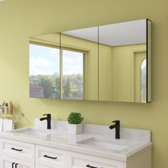 a bathroom with two sinks, mirrors and a window in the wall next to it