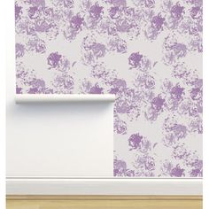 an empty room with purple flowers on the wall