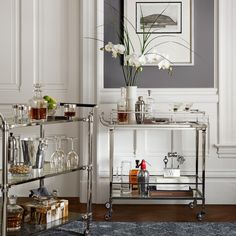 a bar cart filled with glasses and bottles