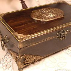 an ornate wooden box sitting on top of a table